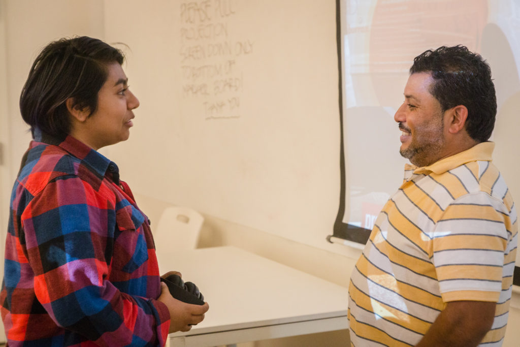 A Woodbury University student talks with Mario after the presentation.